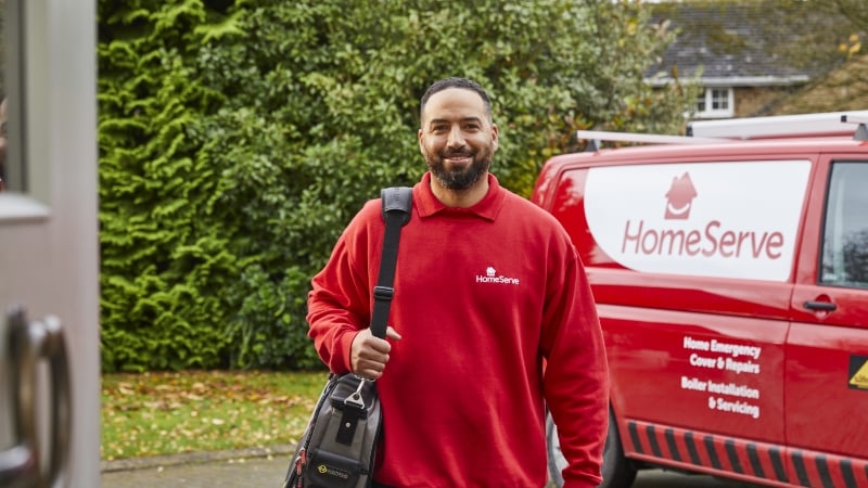 man in HomeServe uniform standing next to van