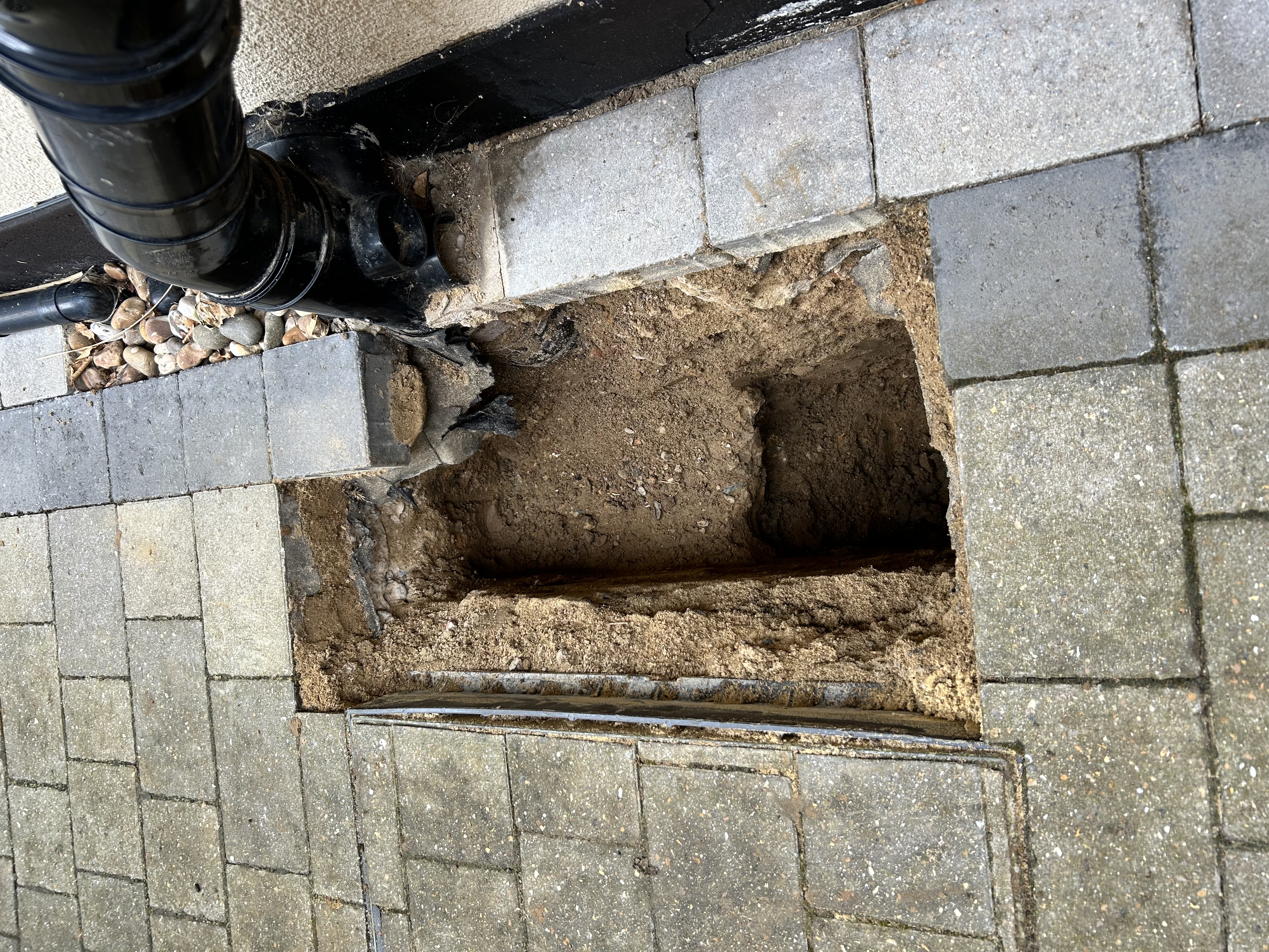 hole in pathway showing trenchless technology