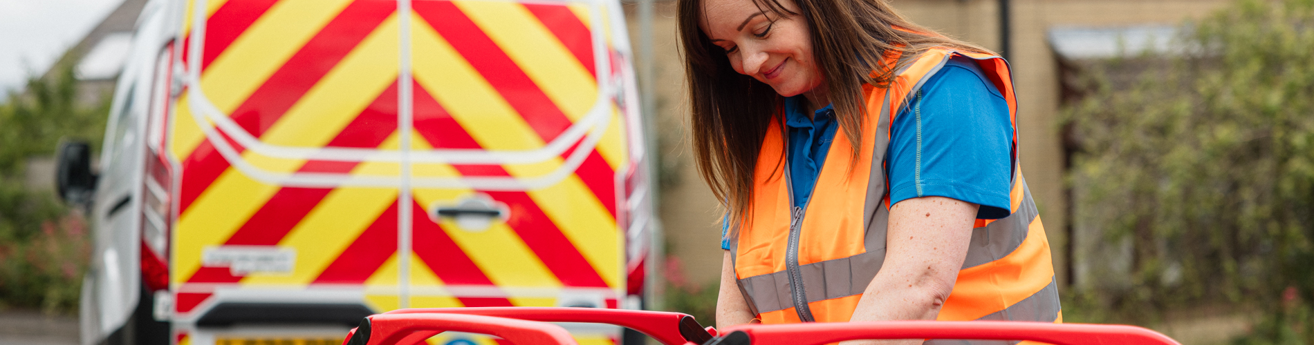 woman in uniform reading water meter